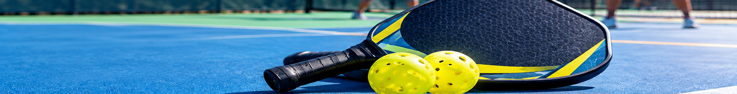 Pickleball court with paddles and balls